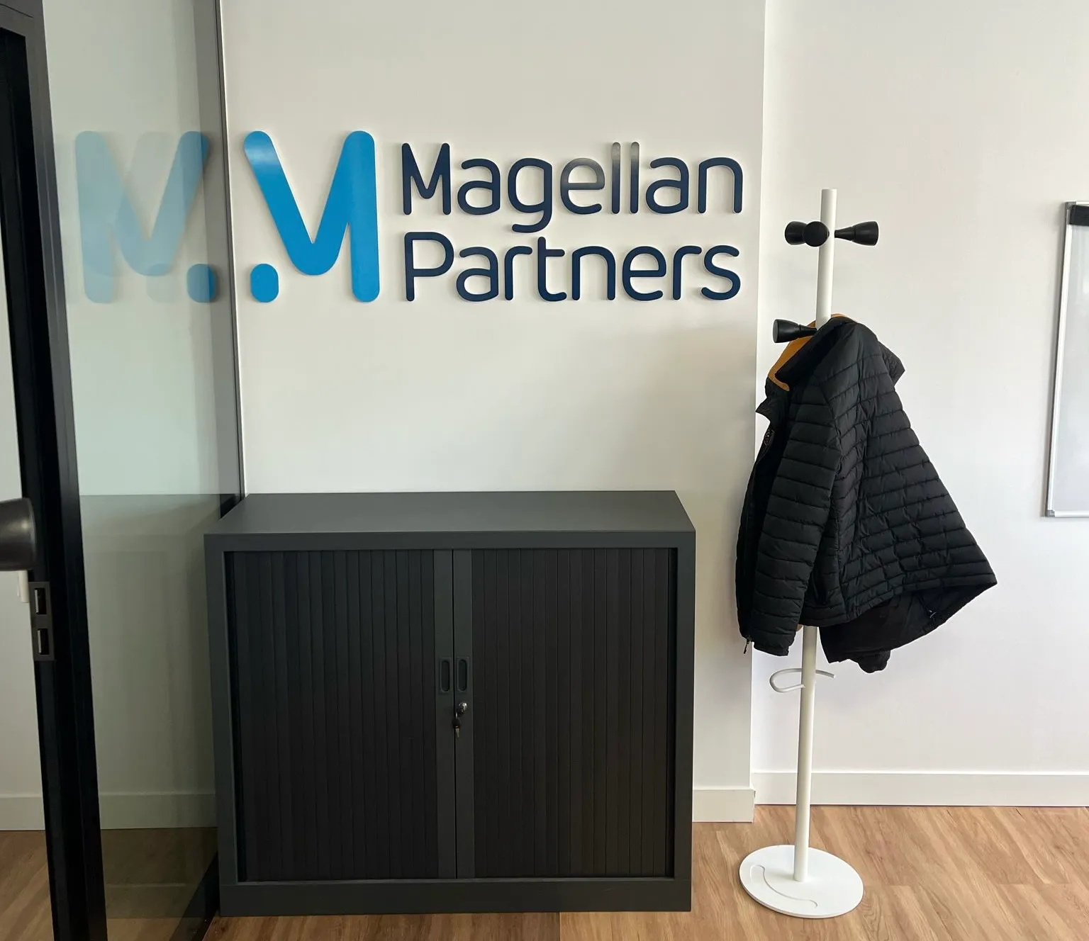 AXYUS, Mérignac — logo Magellan Partners en relief dans un espace de travail — réalisation PUBLI MENI